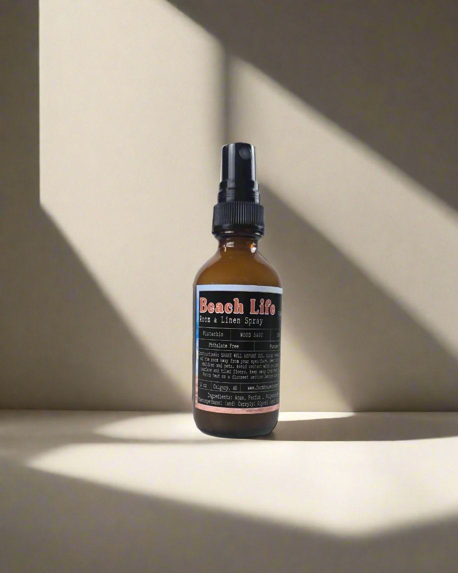 Wrap your space in the warm, nutty aroma of pistachio, cozy wood sage, and a breezy hint of sea salt—like a sun-soaked beach day in every spritz. It's coastal calm in a bottle! Beach Life Room Linen Spray-Farmhouse Charm Candles