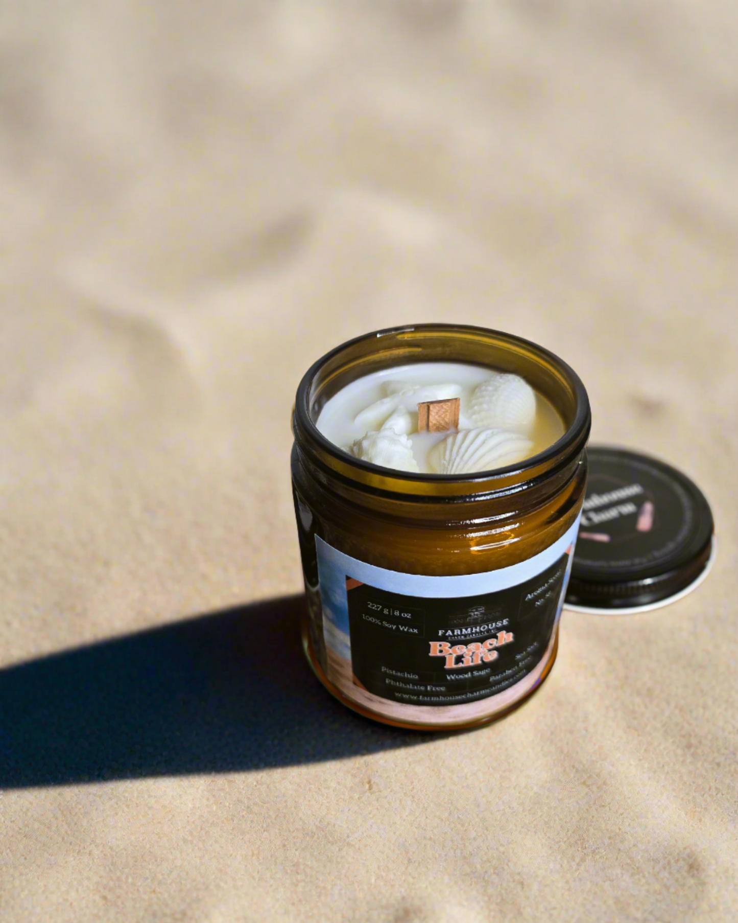Beach Life wraps you in the warm, nutty scent of pistachio, cozy wood sage, and a splash of sea salt—like a sun-kissed beach day captured in a jar.
Topped with handcrafted white sea shell wax embeds, each candle is a mini getaway that’s uniquely yours. Beach Life Soy Candle Farmhouse Charm Candles