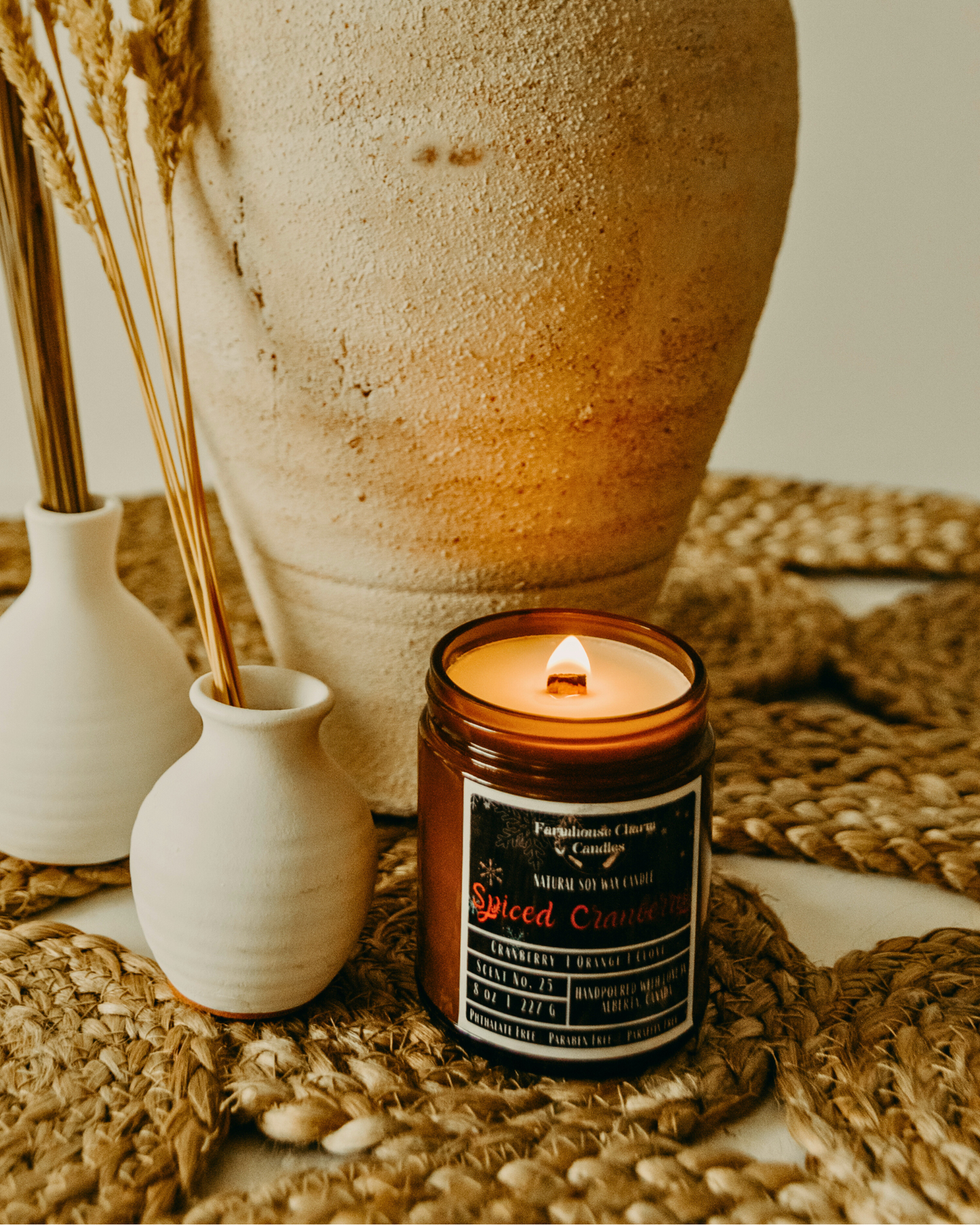 Experience the Festive Season with Spiced Cranberry Soy Candle. Our Spiced Cranberry Soy Candle embodies the true essence of the holiday spirit. The sweet and inviting aroma will fill any room with warmth and comfort. The tart cranberry and mulberry notes provide a refreshing and fruity scent, complemented by the tangy orange that adds a zesty twist. The combination of spicy clove and warm cinnamon creates a cozy ambiance, perfect for chilly winter nights. www.farmhousecharmcandles.com