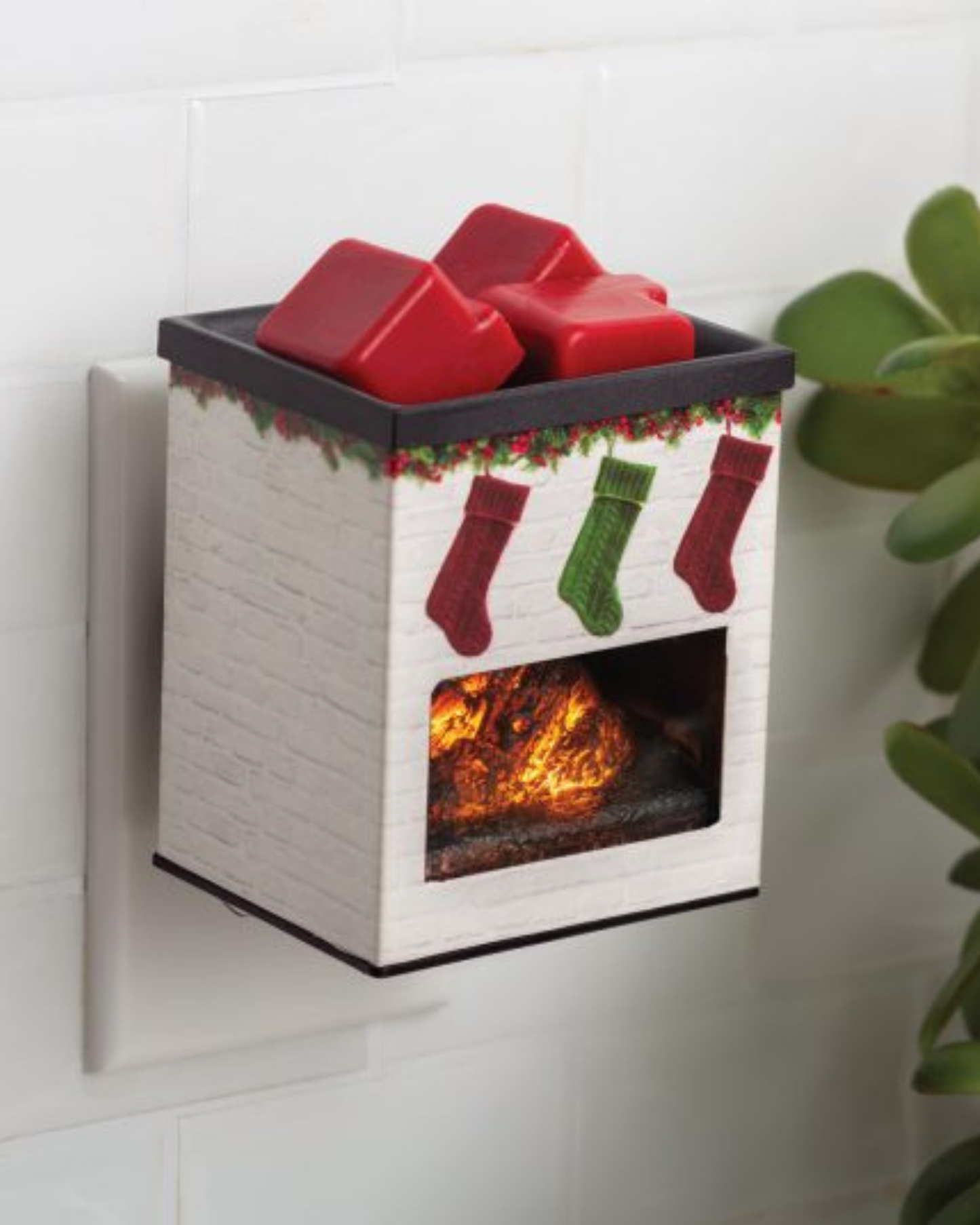 White brick fireplace plug-in fragrance warmer with hanging Christmas stockings design, glowing LED light, and metal applique—ideal for small spaces and use with soy wax melts.