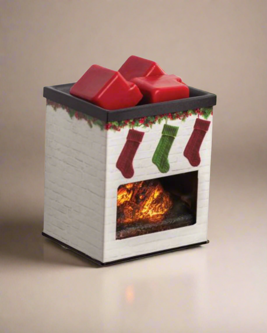 White brick fireplace plug-in fragrance warmer with hanging Christmas stockings design, glowing LED light, and metal applique—ideal for small spaces and use with soy wax melts.
