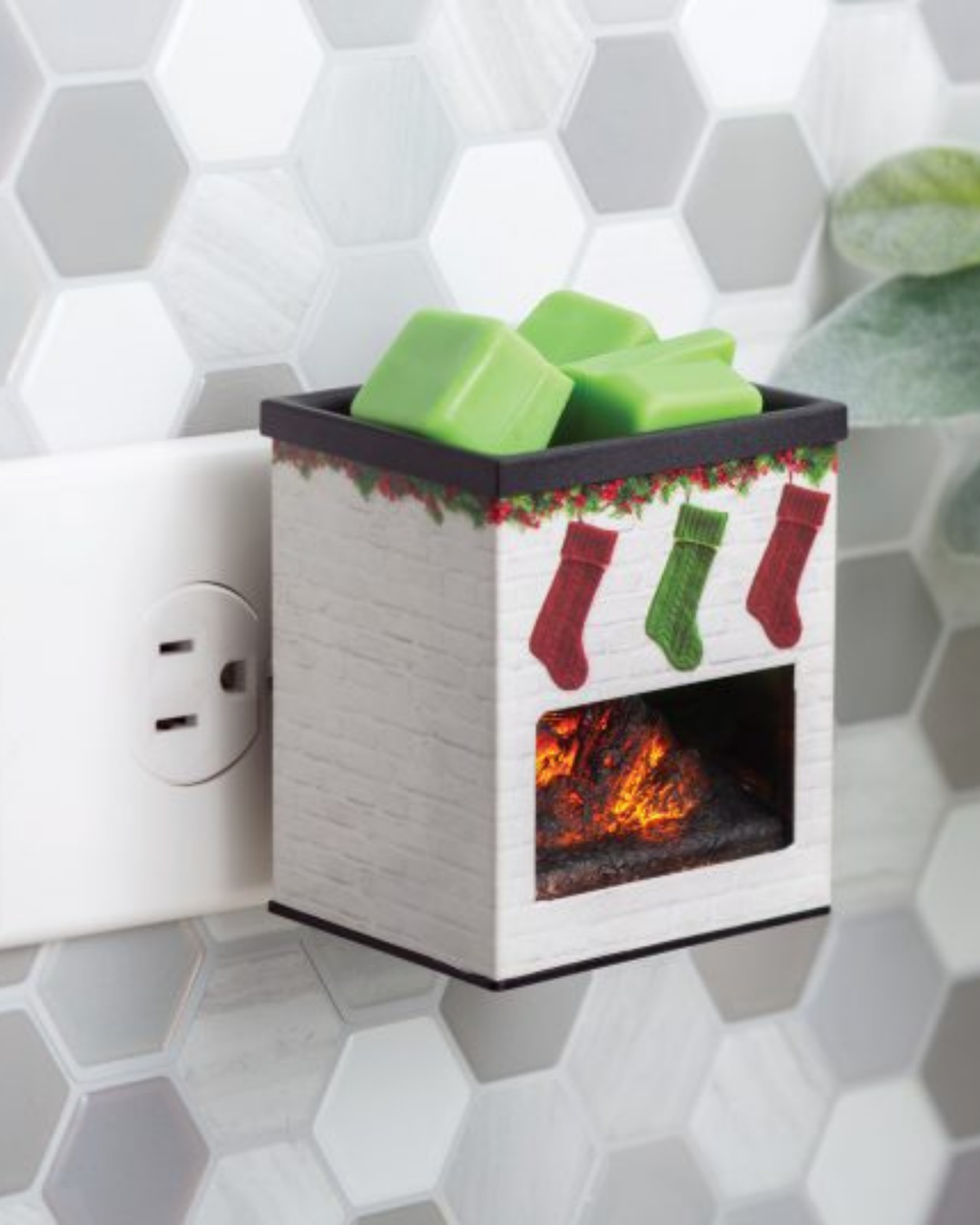 White brick fireplace plug-in fragrance warmer with hanging Christmas stockings design, glowing LED light, and metal applique—ideal for small spaces and use with soy wax melts.