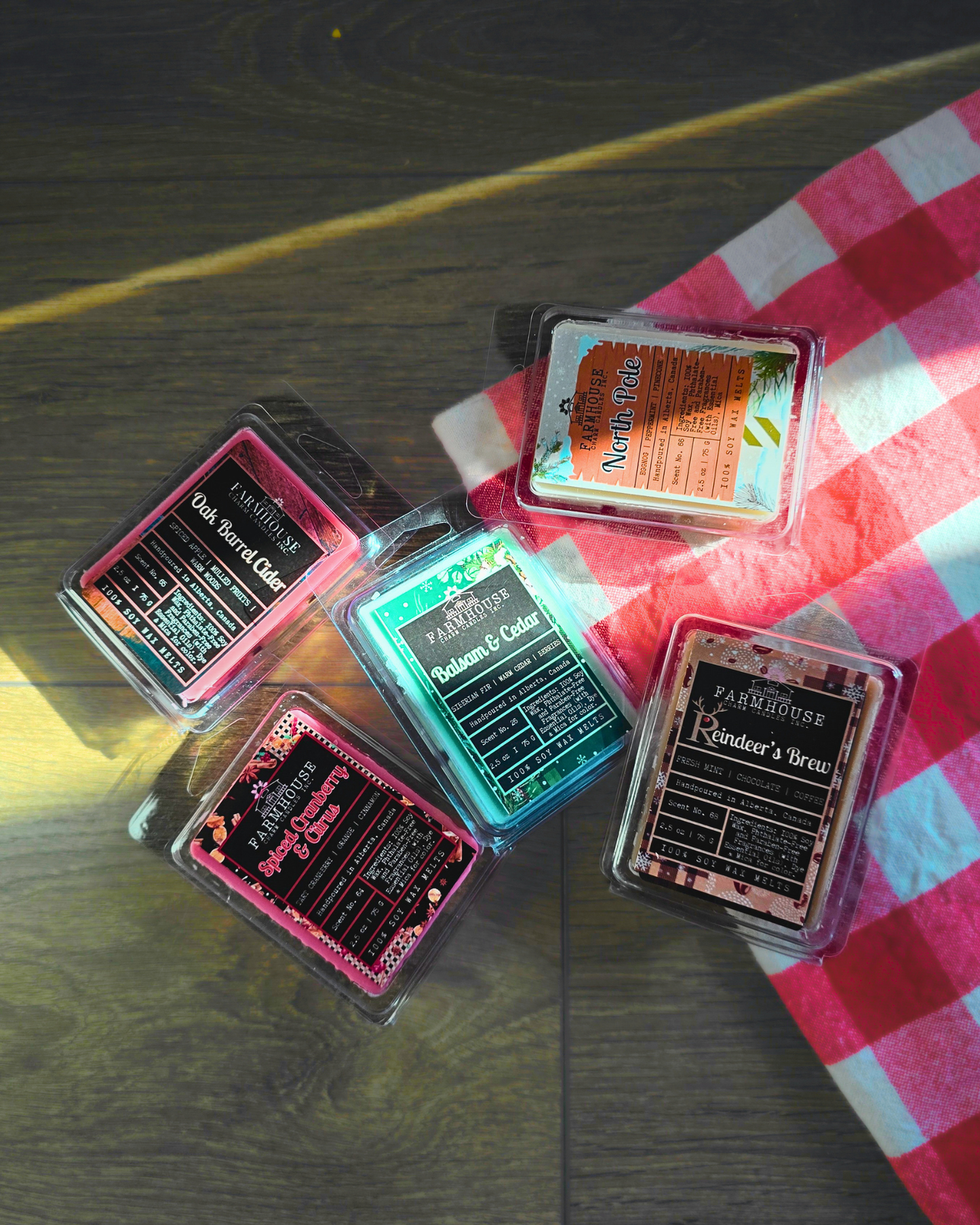 Home for Christmas Wax Melt Bundle by Farmhouse Charm Candles displayed on rustic warm wood with festive blanket