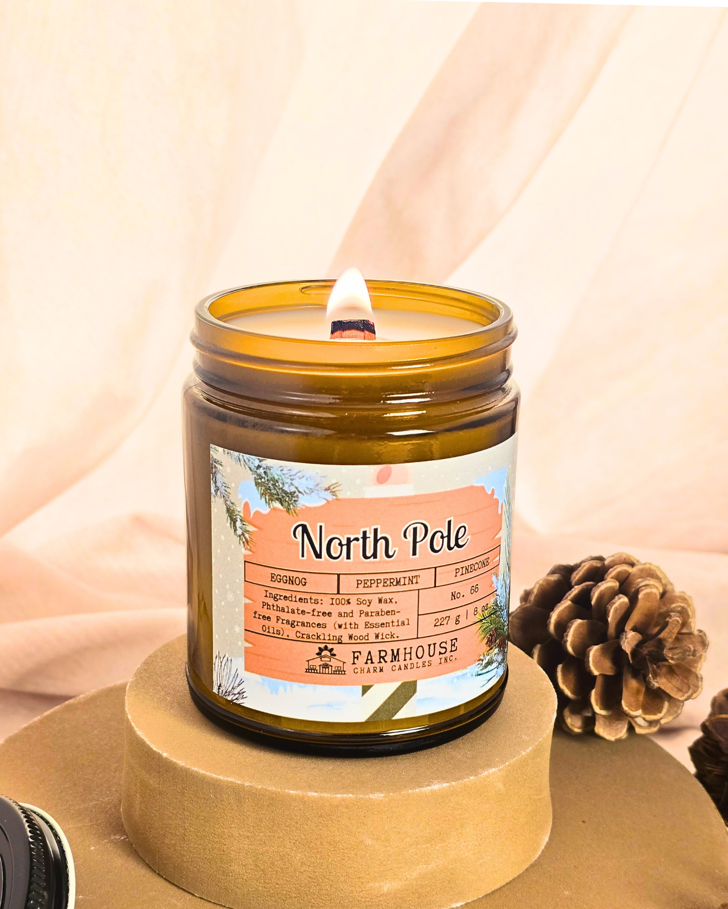 North Pole Soy Candle by Farmhouse Charm Candles — hand-poured soy candle in amber jar with a cozy holiday scent of eggnog, peppermint, and pinecone, styled with festive winter decor.