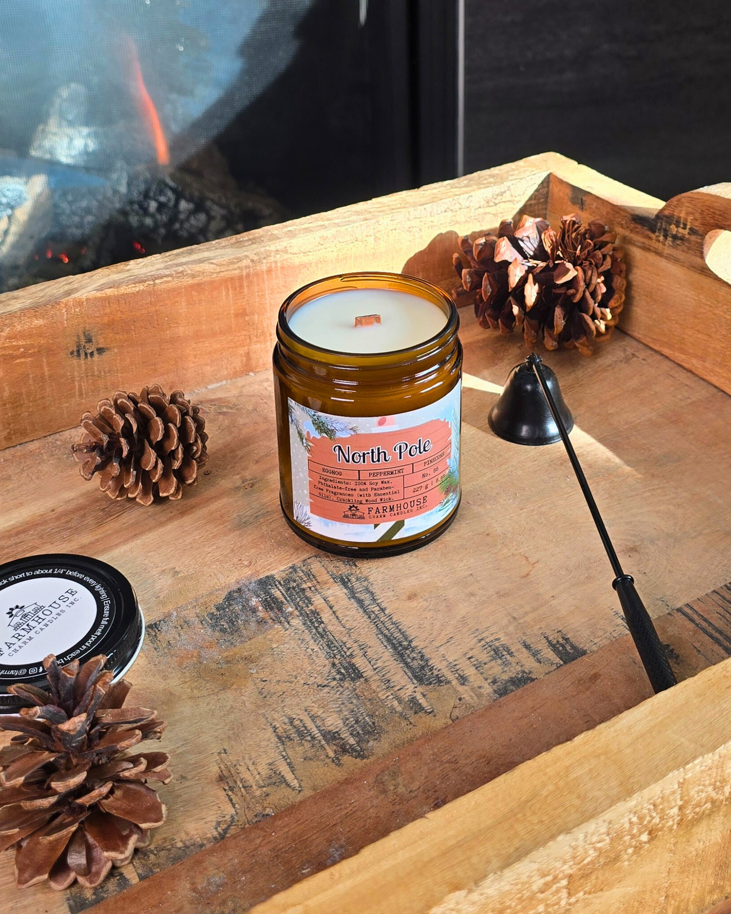 North Pole Soy Candle by Farmhouse Charm Candles — hand-poured soy candle in amber jar with a cozy holiday scent of eggnog, peppermint, and pinecone, styled with festive winter decor.