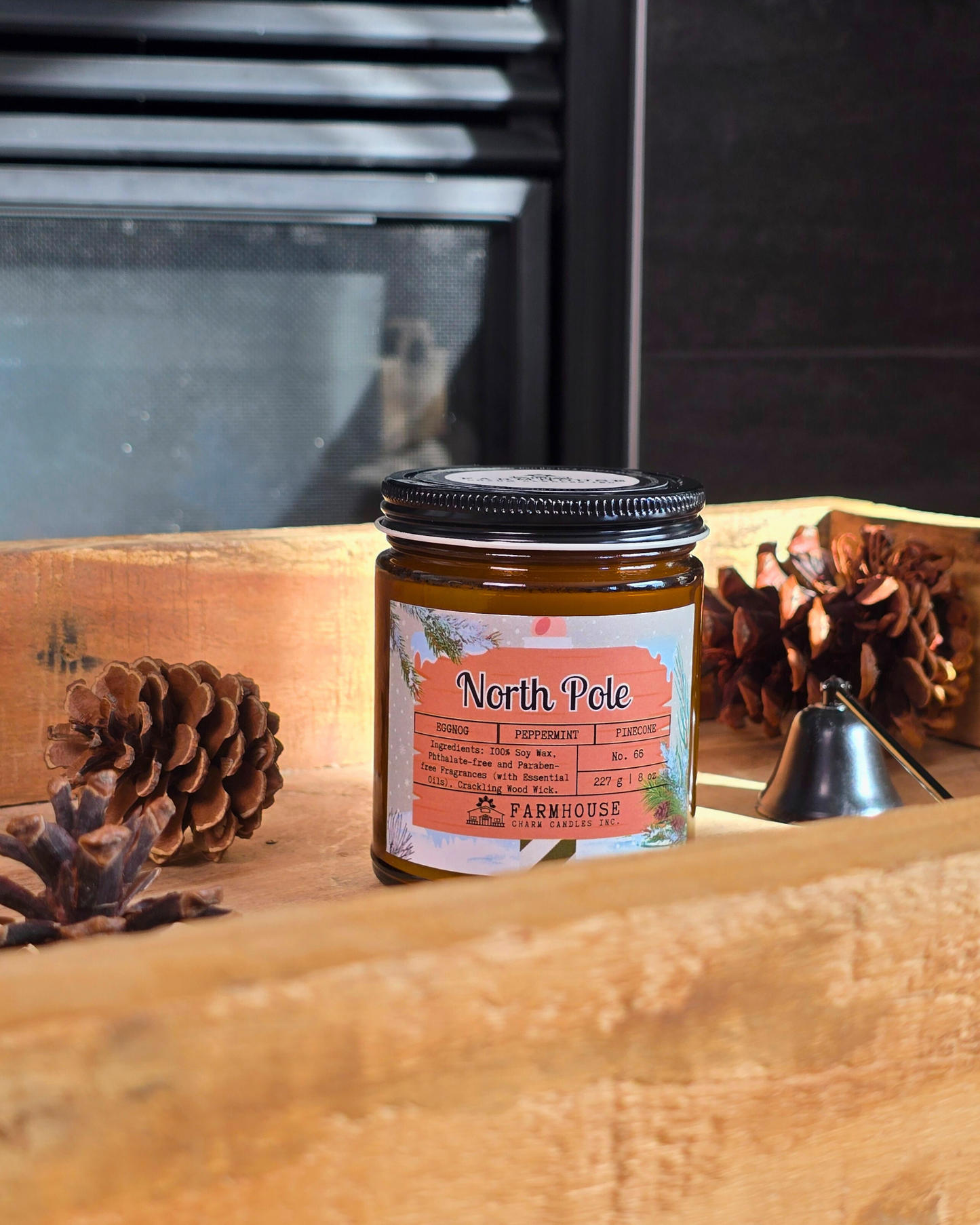 North Pole Soy Candle by Farmhouse Charm Candles — hand-poured soy candle in amber jar with a cozy holiday scent of eggnog, peppermint, and pinecone, styled with festive winter decor.