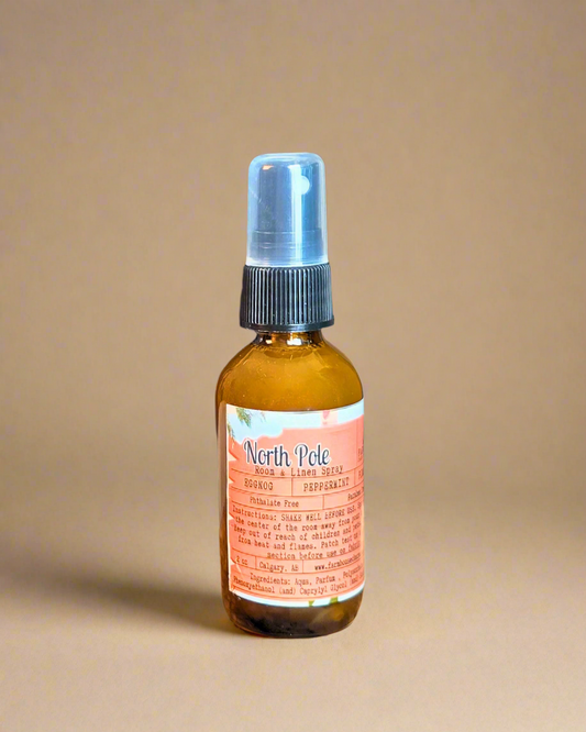 North Pole Room & Linen Spray bottle  capturing the cozy Christmas scent of eggnog, peppermint, and pinecone