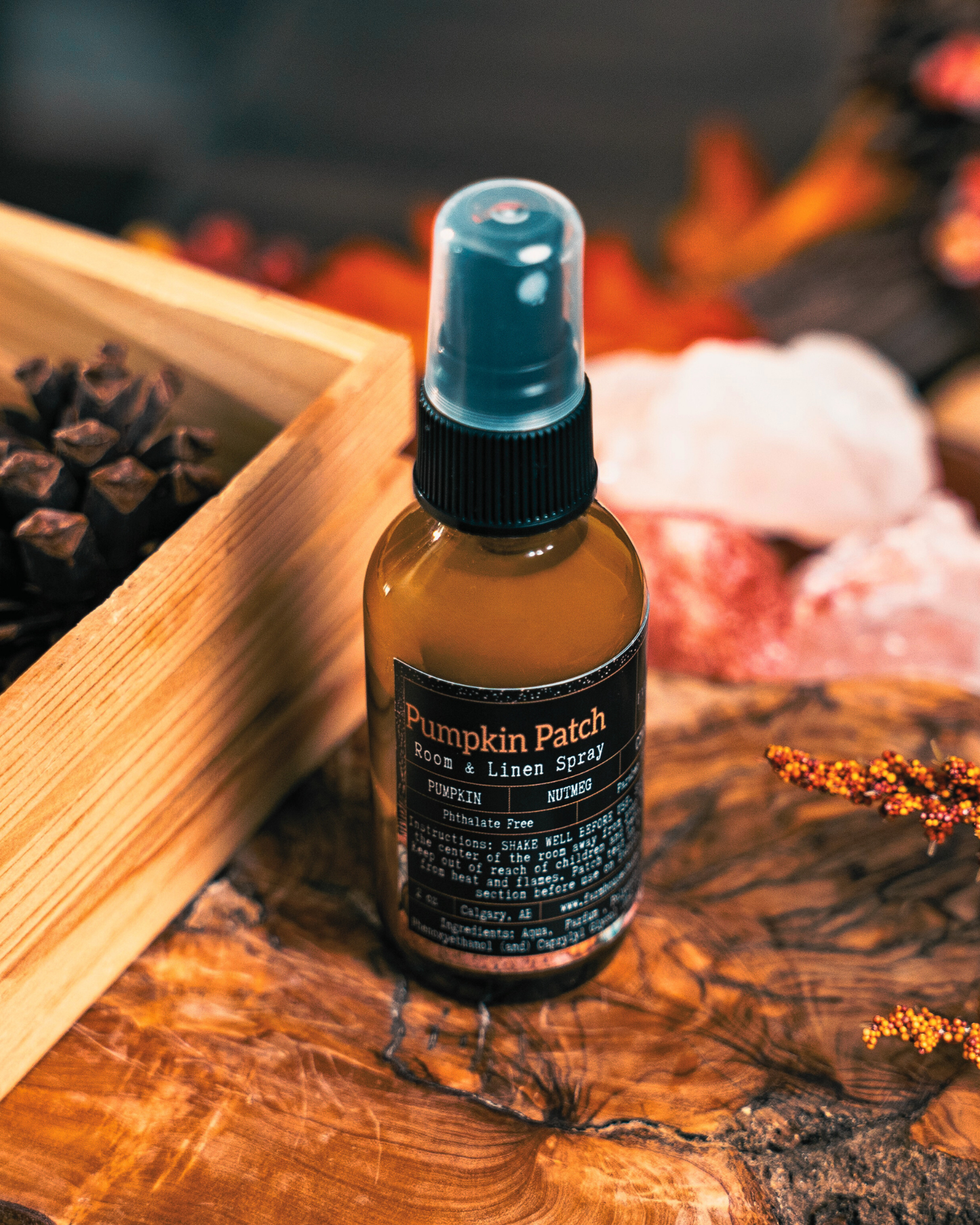 Pumpkin Patch room & linen spray bottle by Farmhouse Charm Candles on a wooden surface with autumn decorations.