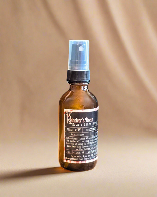 Reindeer’s Brew room and linen spray bottle — festive holiday scent from Farmhouse Charm Candles.