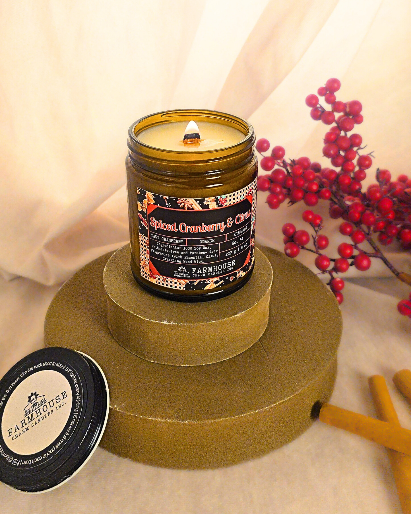Spiced Cranberry & Citrus soy candle by Farmhouse Charm Candle in amber jar surrounded by fresh cranberries and cinnamon sticks — a cozy holiday scent that blends tart, sweet, and warm notes.