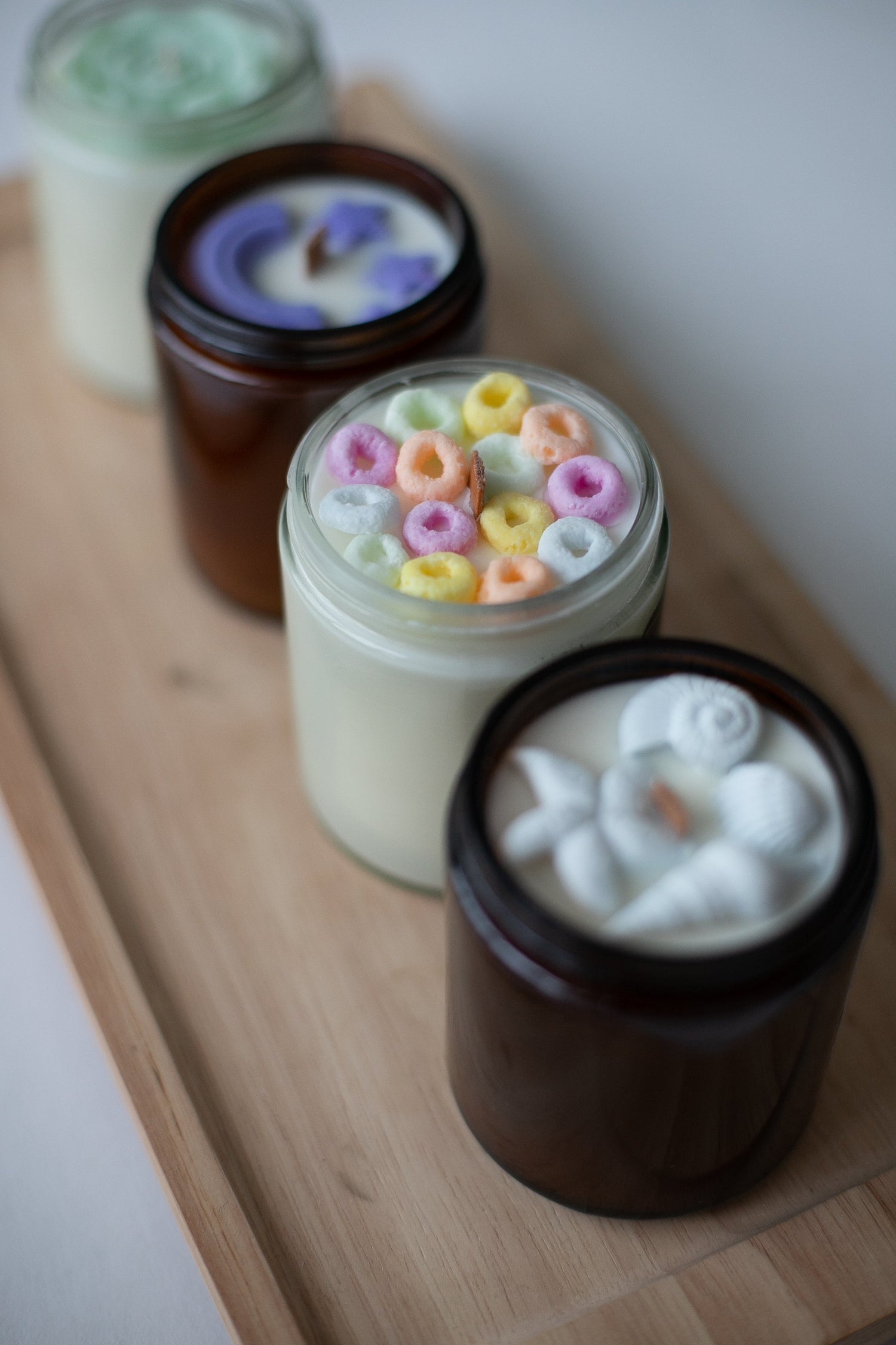 The Signature Charm Collection by Farmhouse Charm  candles feature charming wax toppings