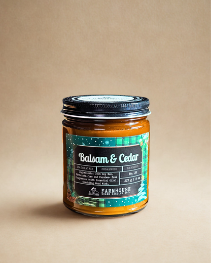 Jar of 'Balsam & Cedar by Farmhouse Charm Candle on a beige background