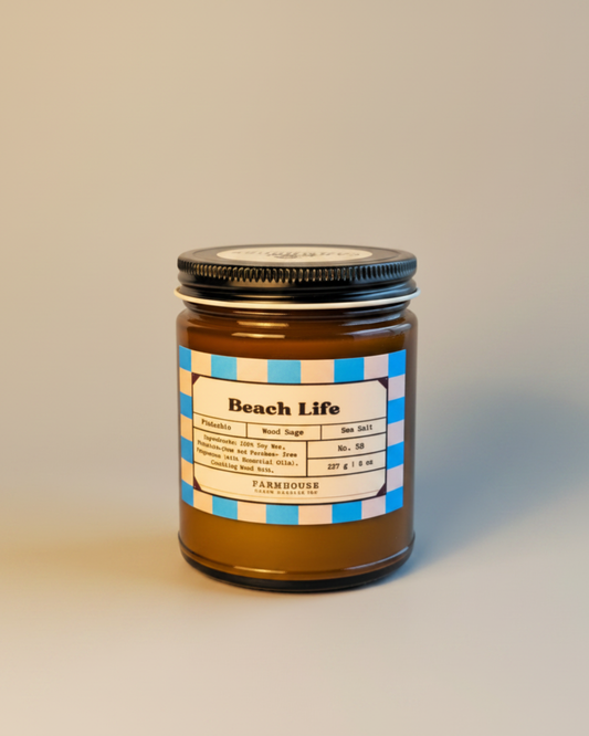 Jar labeled 'Beach Life' with seashells on a neutral background by Farmhouse Charm Candles