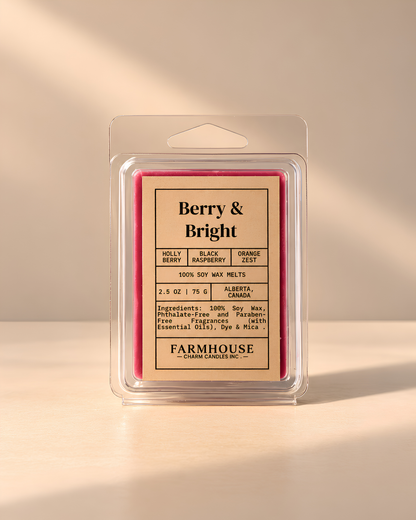 A packaged 100% soy wax melt in a clear plastic clamshell container with a hanger tab. The label reads 'Berry & Bright' by Farmhouse Charm Candles and shows a pink berry illustration, with scent notes including holly berry, black raspberry, orange zest, and Alberta, Canada.
