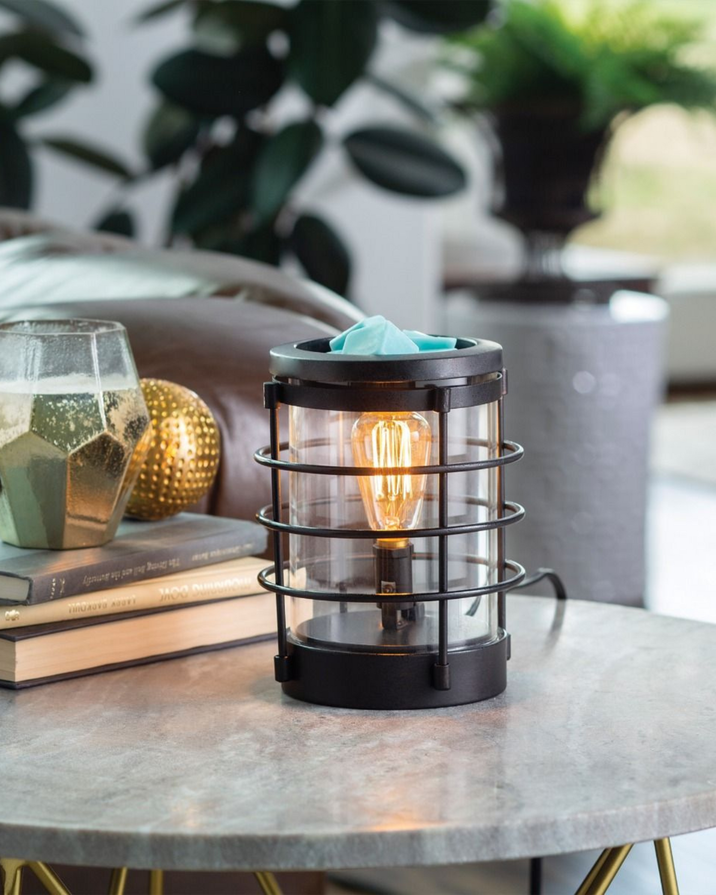 An updated traditional style with wire framing in a matte black finish give this Vintage Bulb Illumination a classic lantern feel. Illumination Fragrance Warmers use a Vintage Bulb to warm wax melts in the dish, releasing their fragrance.   Suggested Use: Simply add wax melts to the dish, turn it on, and enjoy your favorite fragrance as it spreads through the room. This warmer works beautifully with 100% Soy Wax Melts by Farmhouse Charm Candles Inc.