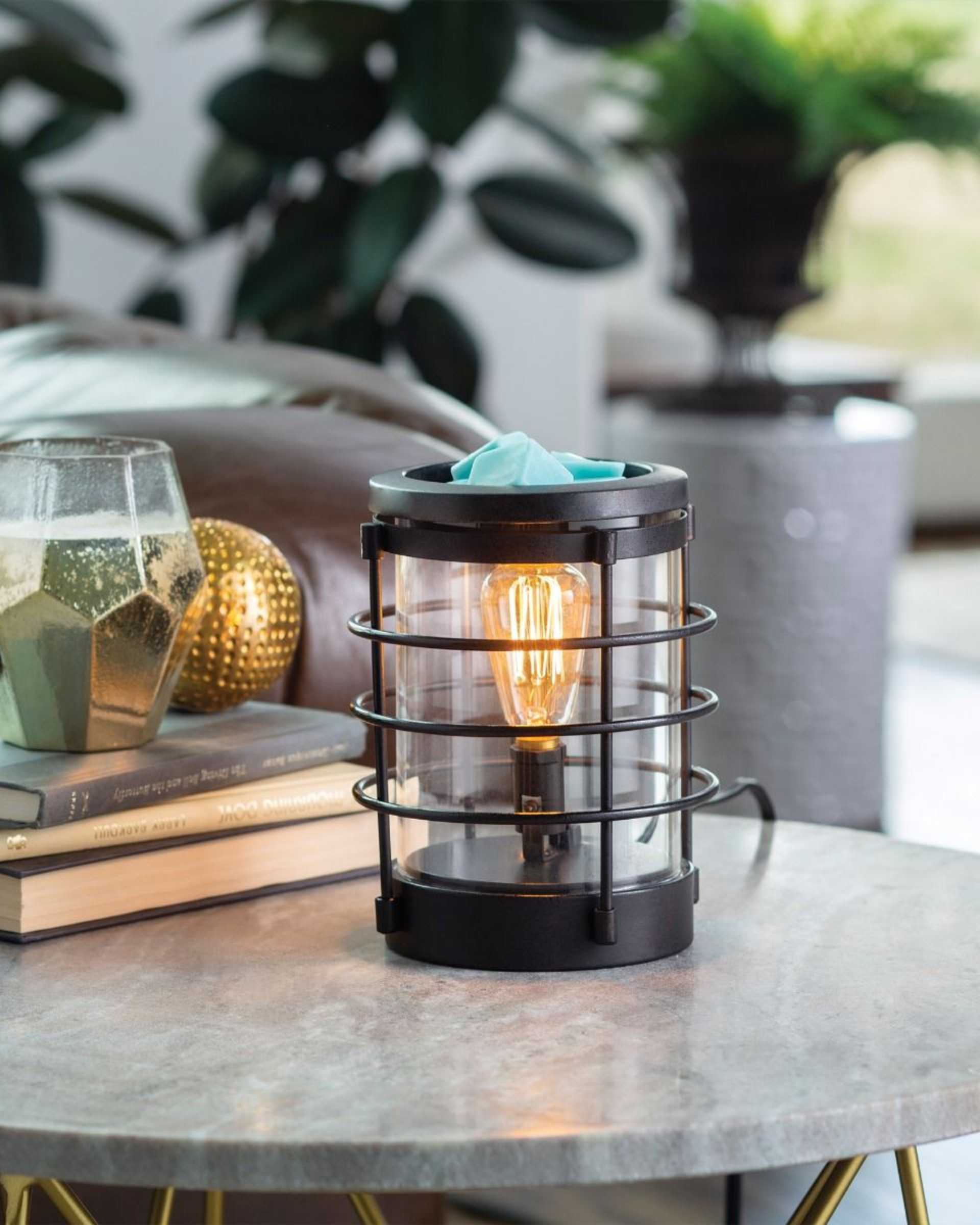 An updated traditional style with wire framing in a matte black finish give this Vintage Bulb Illumination a classic lantern feel. Illumination Fragrance Warmers use a Vintage Bulb to warm wax melts in the dish, releasing their fragrance.   Suggested Use: Simply add wax melts to the dish, turn it on, and enjoy your favorite fragrance as it spreads through the room. This warmer works beautifully with 100% Soy Wax Melts by Farmhouse Charm Candles Inc.