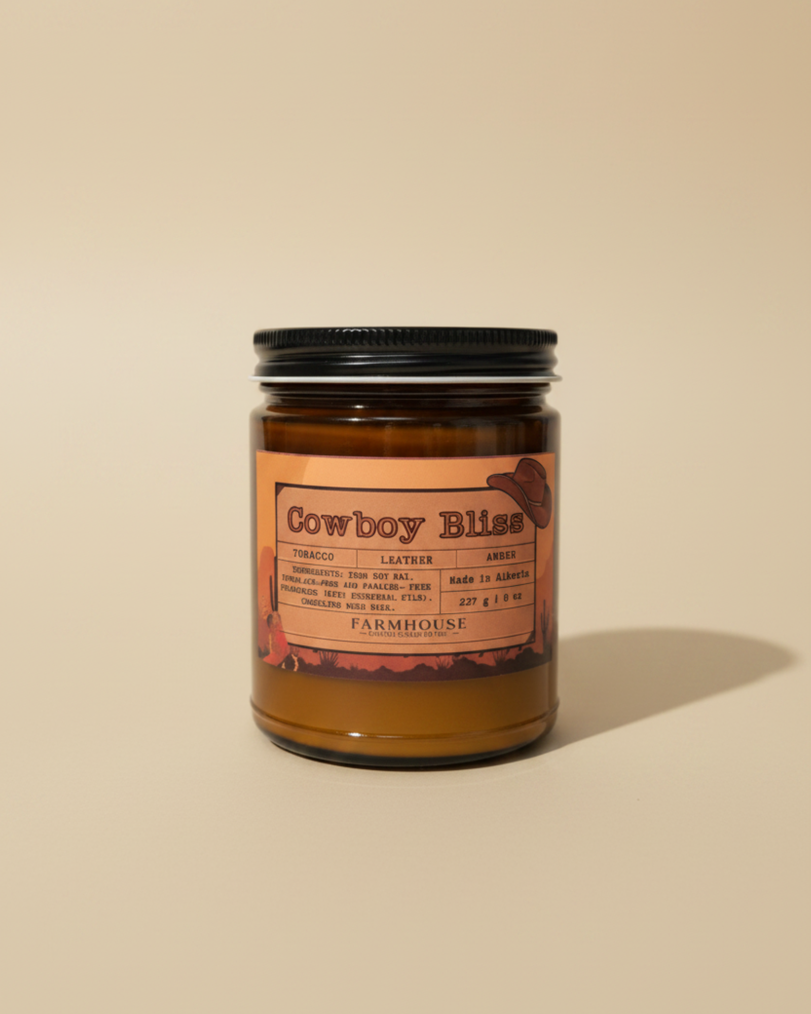  candle in amber jar with wood wick, western label, tobacco/leather/amber notes. Cowboy Bliss by Farmhouse Charm Candles