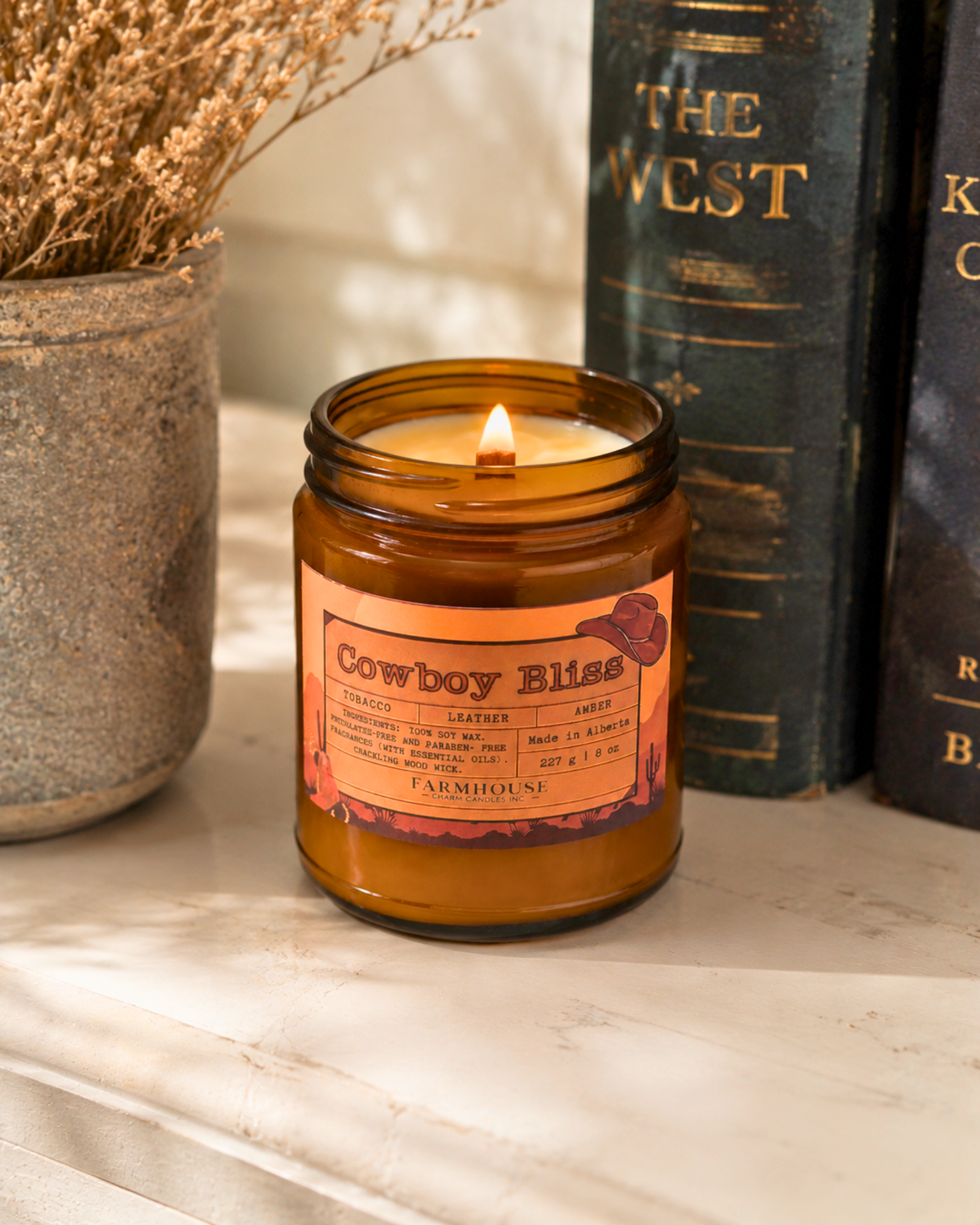 candle in amber jar with wood wick, western label, tobacco/leather/amber notes. cowboy bliss by Farmhouse Charm Candles