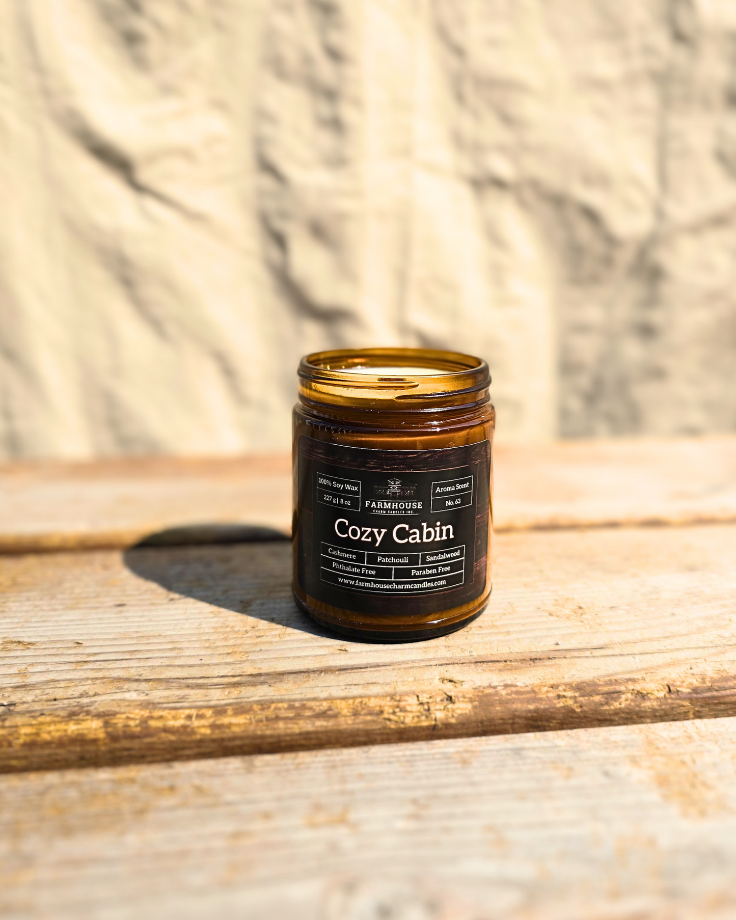 Imagine curling up by a crackling fire, wrapped in a soft cashmere blanket, as the warm, woodsy aroma of sandalwood and patchouli fills the air. This rich, inviting scent feels like your favorite sweater on a chilly evening—soft, comforting, and oh-so-cozy. www.farmhousecharmcandles.com