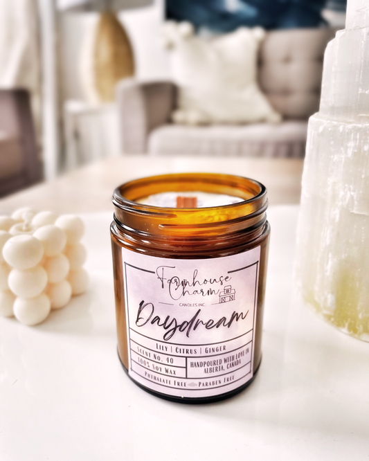 Aroma Scent No. 40 Daydream Soy Candle, a captivating blend designed to ignite inspiration and manifest your dreams. Infused with a medley of citrusy, floral, and spicy notes, this unique fragrance is a delightful fusion of lily's fresh florals, gently accented by hints of ginger and underlying citrus undertones. These impactful scents serve as a gateway to a realm of positivity, tranquility, and imaginative flair, empowering you to embrace and live out your daydreams. www.farmhousecharmcandles.com