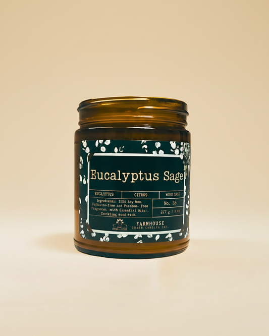 Candle jar labeled 'Eucalyptus Sage' by Farmhouse Charm Candles on a beige background