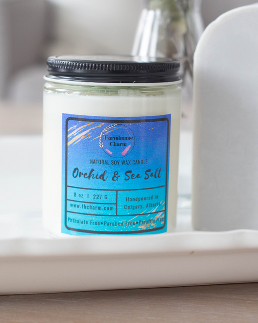Experience the invigorating aroma of Orchid & Sea Salt - Farmhouse Charm Natural Soy Candle . This soy candle offers a delightful blend of soft floral tones, including orchid, jasmine, and lily. The crisp and refreshing sea salt mist aroma adds an elegant touch to the fragrance, making it truly invigorating. The stunning mint-green soy wax top is shaped like a succulent, making it a unique addition to your decor. www.farmhousecharmcandles.com