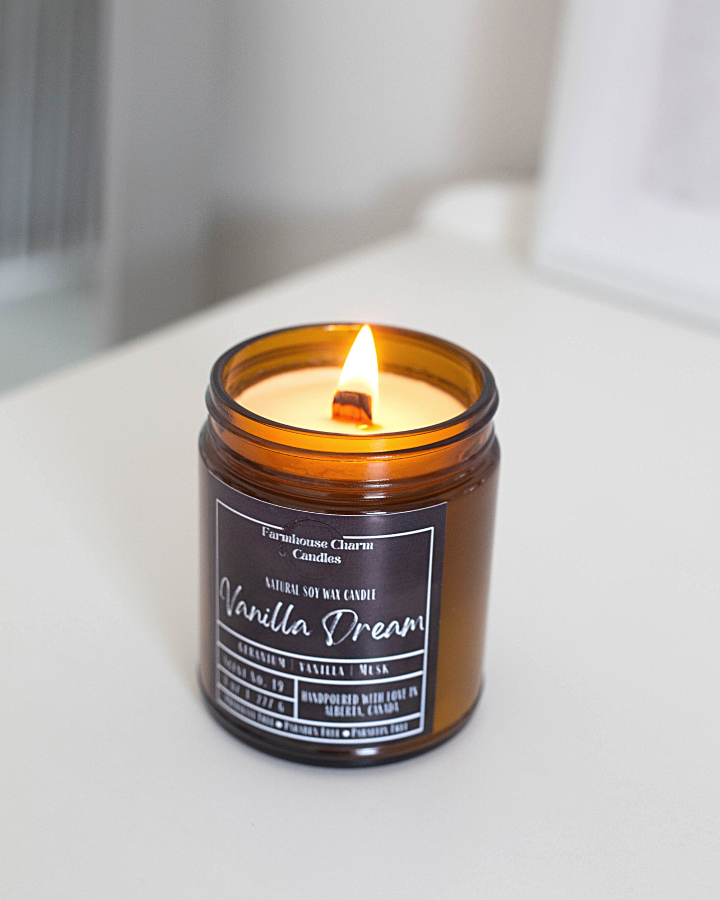 Experience the luxurious aroma of Vanilla Dream- Farmhouse Charm Soy Candle. Step up your candle game with this unique vanilla fragrance that will not disappoint. Indulge in a dreamy and lavish scent that awakens your senses with a blend of toasted vanilla, sweet geranium florals, and a touch of musk.  size: 8 oz (227 g)  The candle is hand poured with love in Alberta, Canada. It has an approximate burn time of 50 hours.