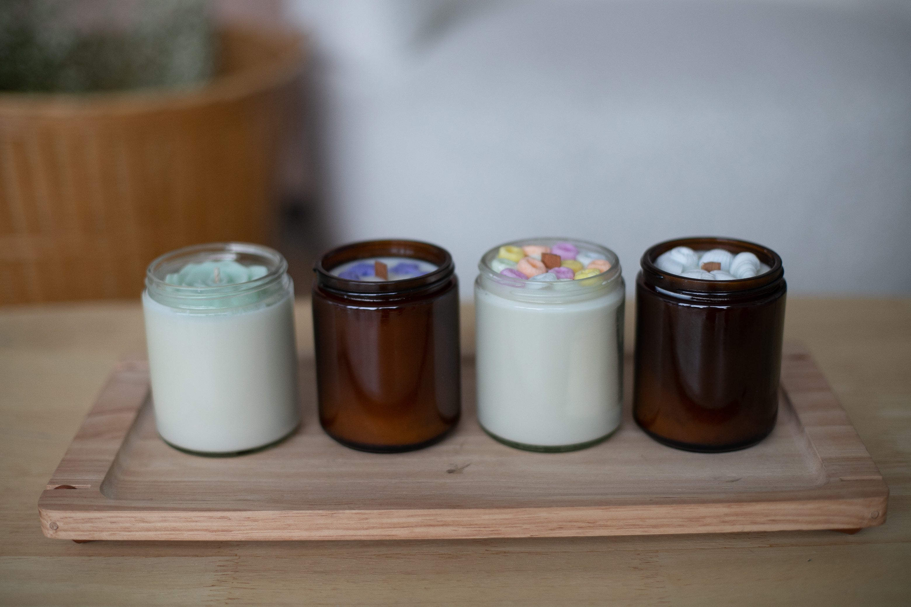  candles with wax decorative charm on top labels on a wooden surface by Farmhouse Charm Candles