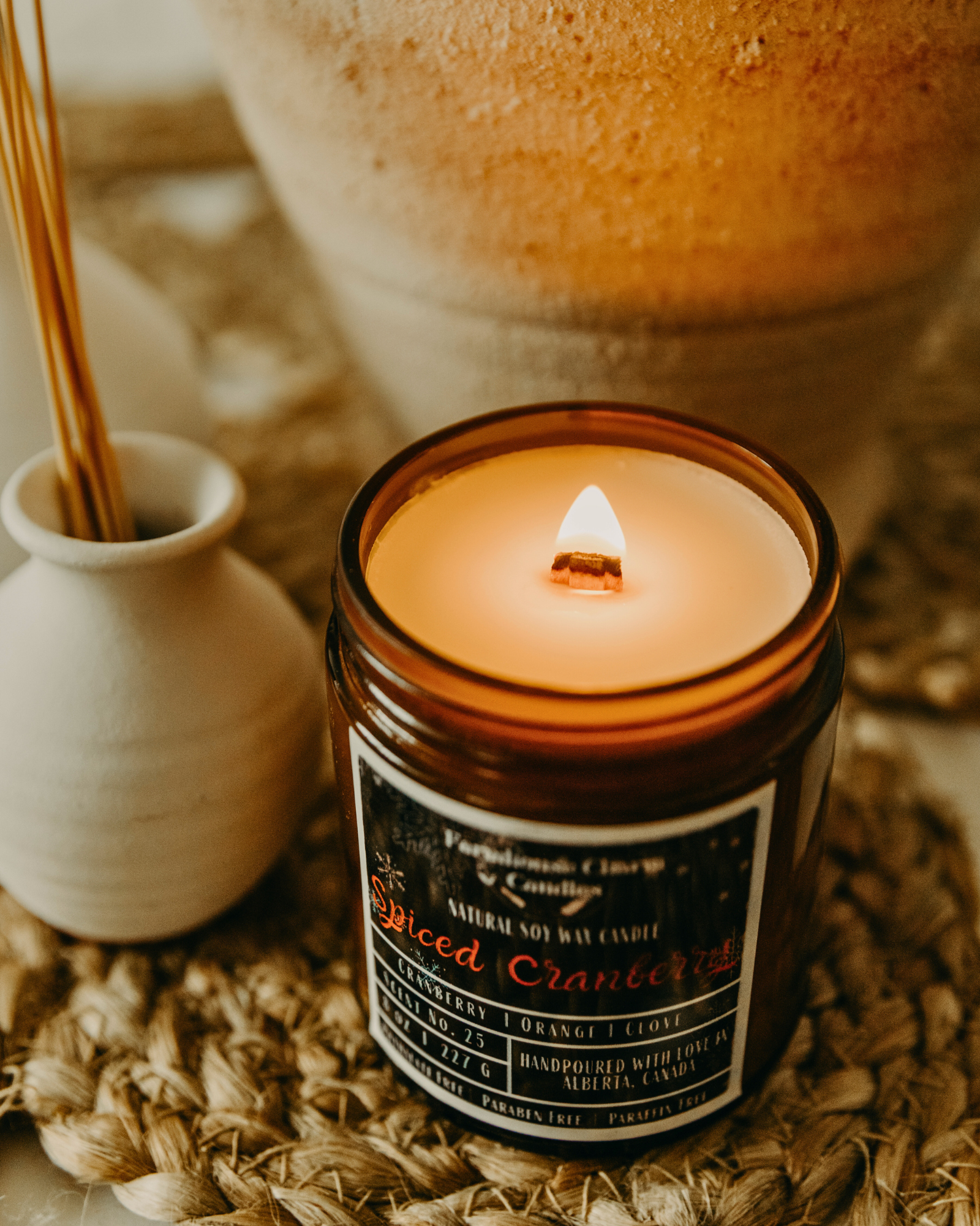 Experience the Festive Season with Spiced Cranberry Soy Candle.  Our Spiced Cranberry Soy Candle embodies the true essence of the holiday spirit. The sweet and inviting aroma will fill any room with warmth and comfort. The tart cranberry and mulberry notes provide a refreshing and fruity scent, complemented by the tangy orange that adds a zesty twist. The combination of spicy clove and warm cinnamon creates a cozy ambiance, perfect for chilly winter nights. www.farmhousecharmcandles.com