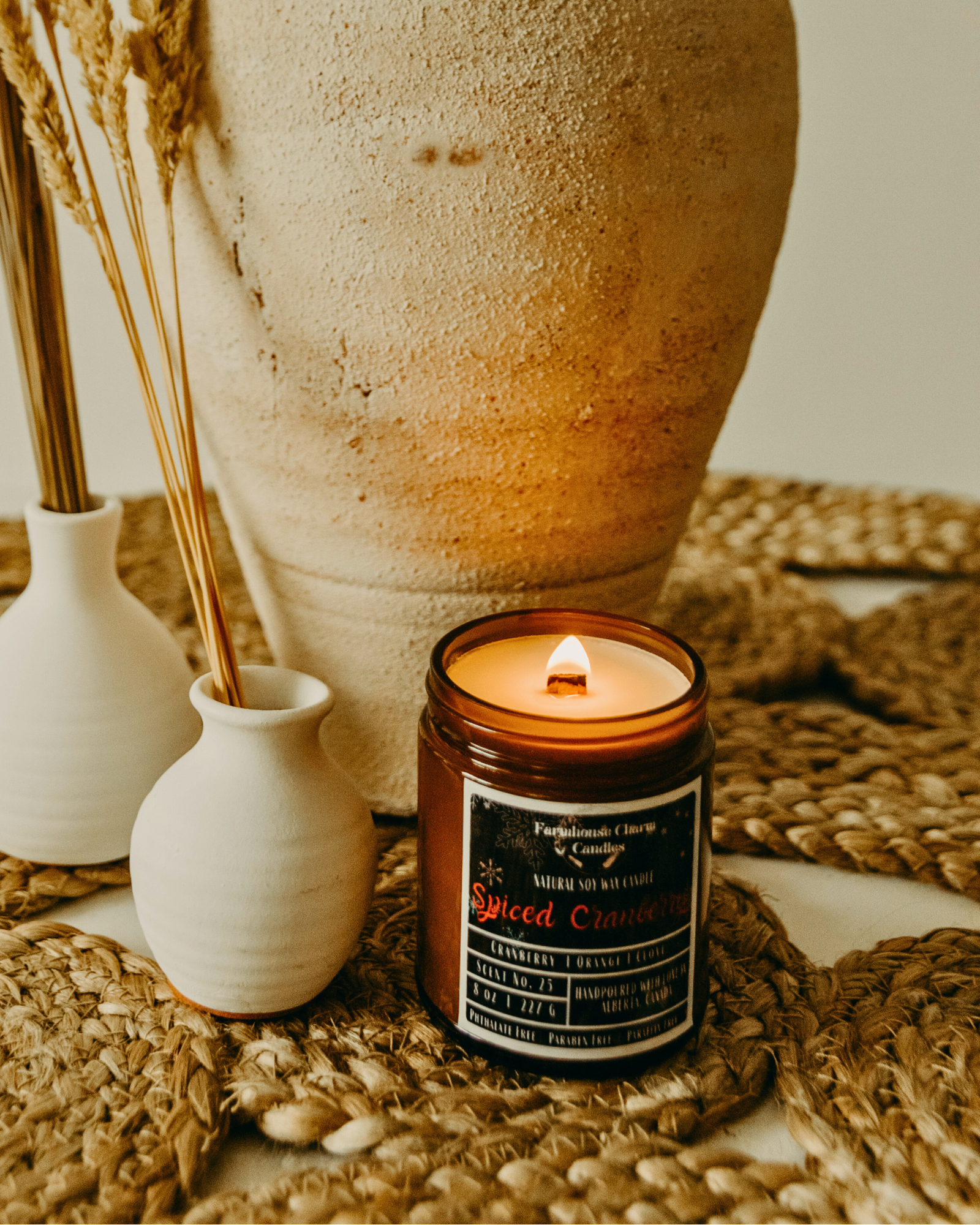 Experience the Festive Season with Spiced Cranberry Soy Candle.  Our Spiced Cranberry Soy Candle embodies the true essence of the holiday spirit. The sweet and inviting aroma will fill any room with warmth and comfort. The tart cranberry and mulberry notes provide a refreshing and fruity scent, complemented by the tangy orange that adds a zesty twist. The combination of spicy clove and warm cinnamon creates a cozy ambiance, perfect for chilly winter nights. www.farmhousecharmcandles.com