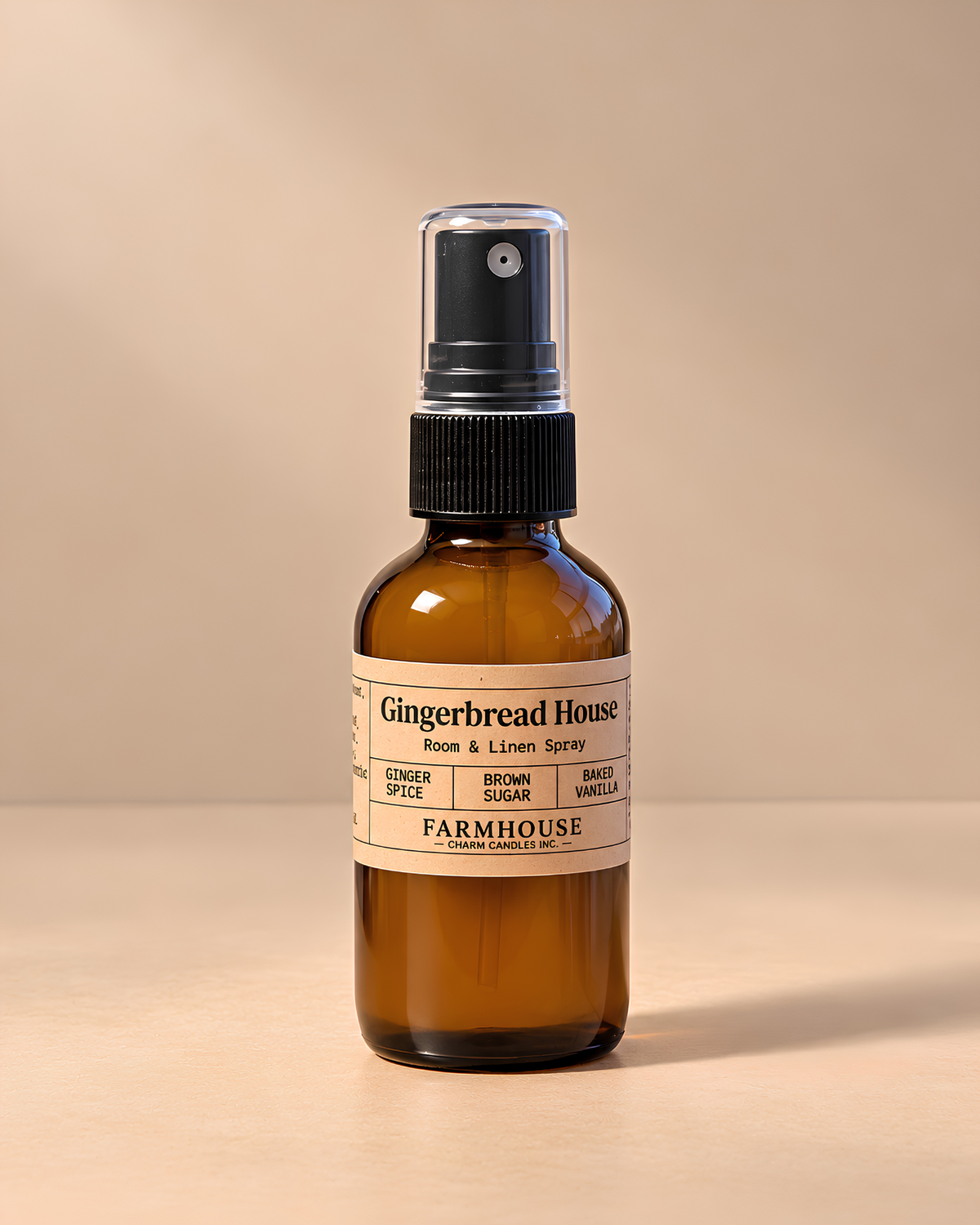 An amber glass spray bottle with a black pump dispenser and a cream-colored label reading 'Gingerbread House Face & Lichen Spray' by Farmhouse Charm Candles set against a warm beige background.