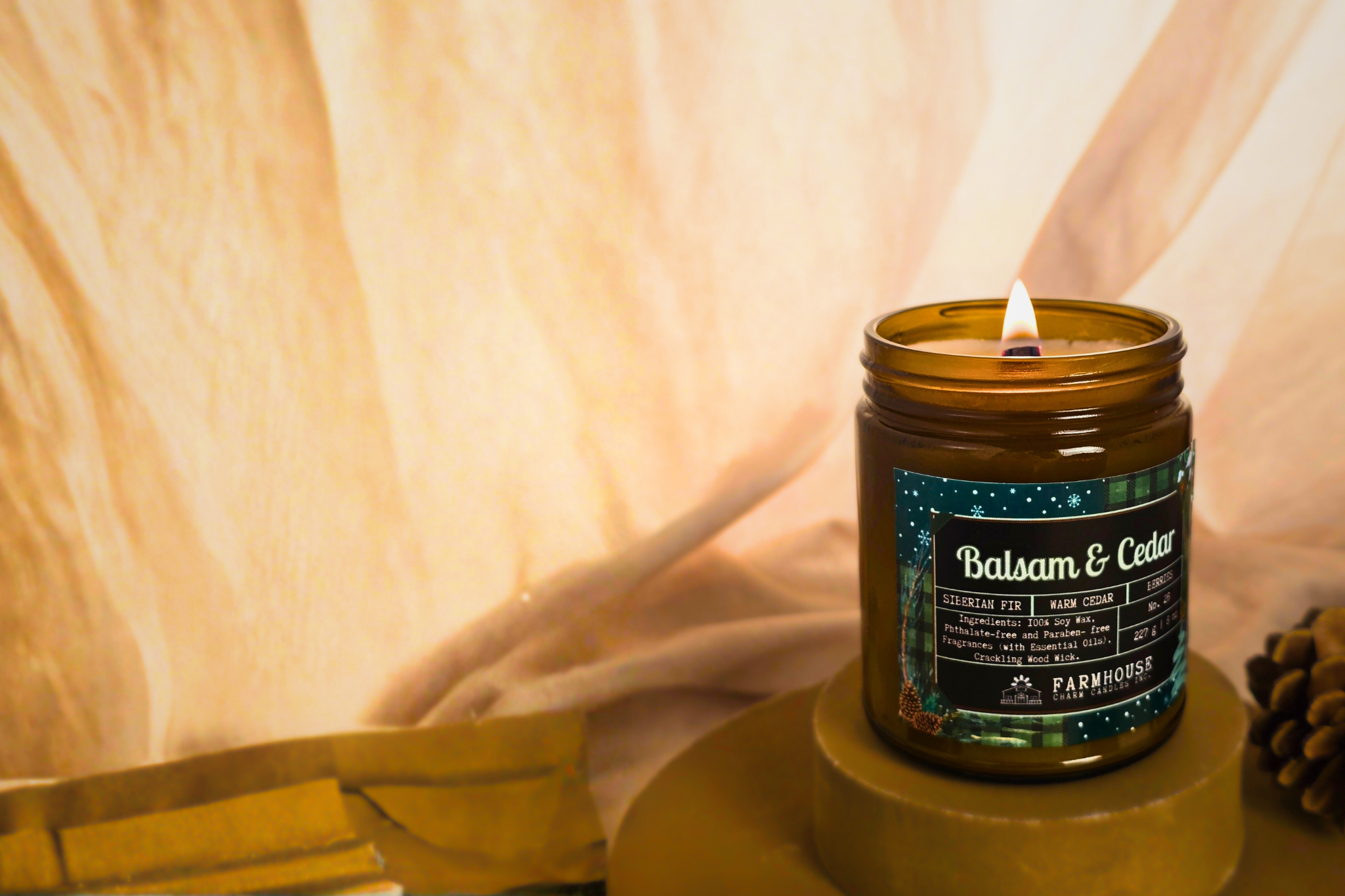 Candle with 'Balsam & Cedar' label on a neutral background by Farmhouse Charm Candles