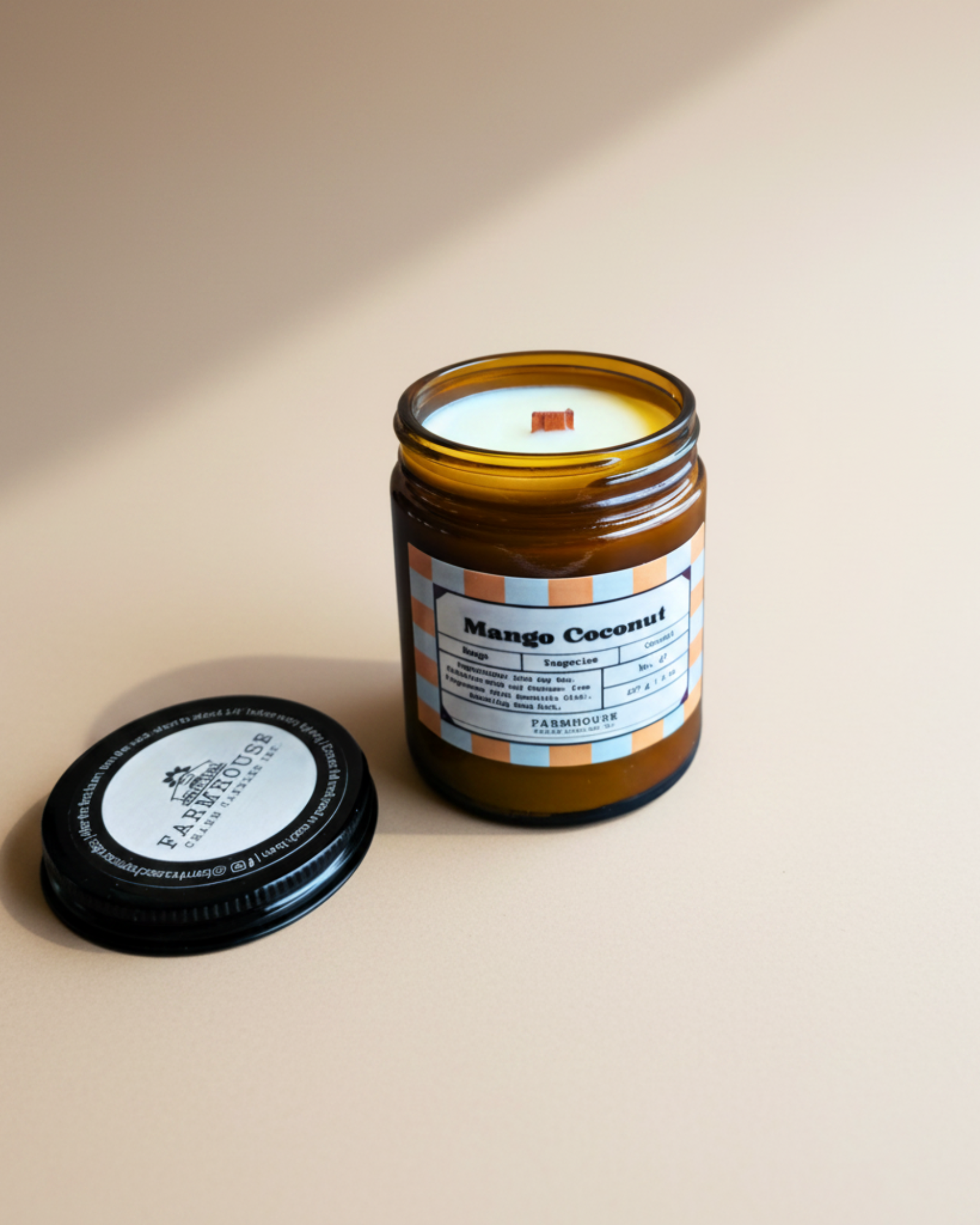 Mango Coconut candle by Farmhouse Charm Candles in an amber glass jar with a checkered label on a white background