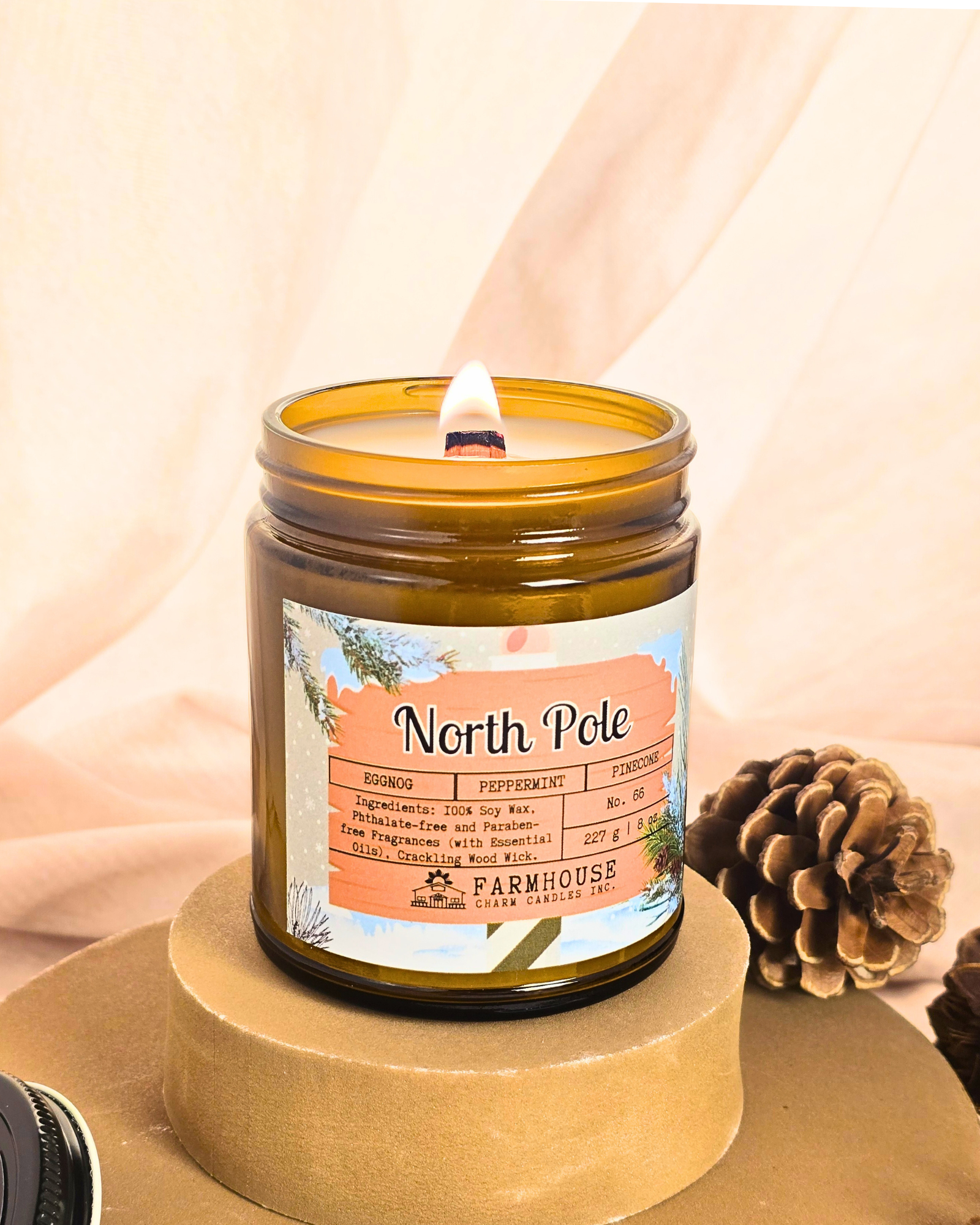 North Pole Soy Candle by Farmhouse Charm Candles — hand-poured soy candle in amber jar with a cozy holiday scent of eggnog, peppermint, and pinecone, styled with festive winter decor.