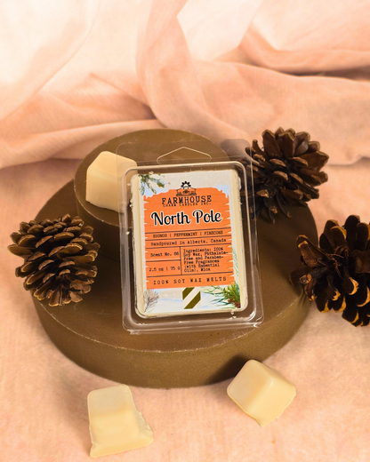 North Pole Wax Melts — creamy eggnog, cool peppermint, and pinecone scent soy wax melts displayed in a cozy farmhouse setting with festive holiday accents.