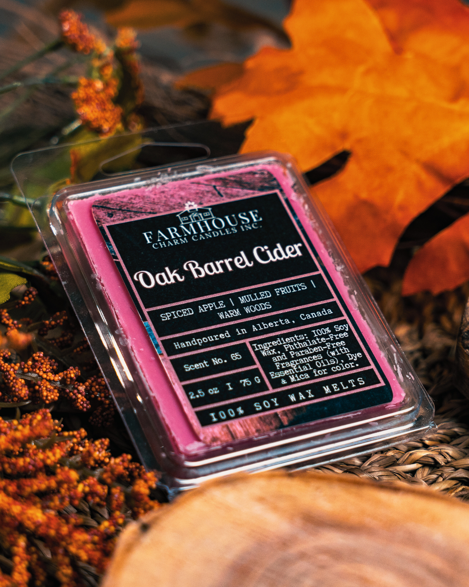 Farmhouse Charm Candles Oak Barrel Cider soy wax melt with a autumn-themed background.