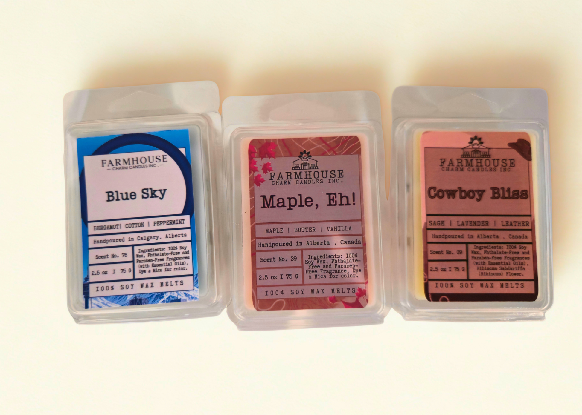 Three wax melts in clear packaging with labels on a white background