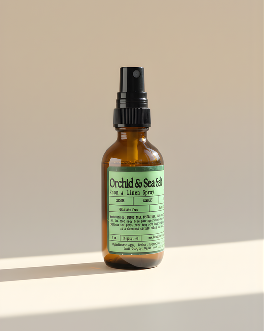 Amber room & Linen spray bottle with Orchid & Sea Salt label on a beige background by Farmhouse Charm Candles