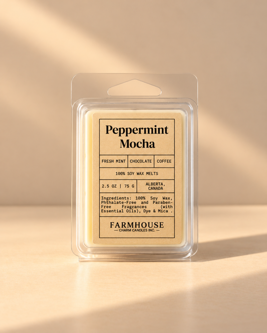 A packaged wax melt product labeled 'Peppermint Mocha' by Farmhouse Charm Candles, shown in a clear plastic clamshell package on a warm beige background with soft diagonal shadows.