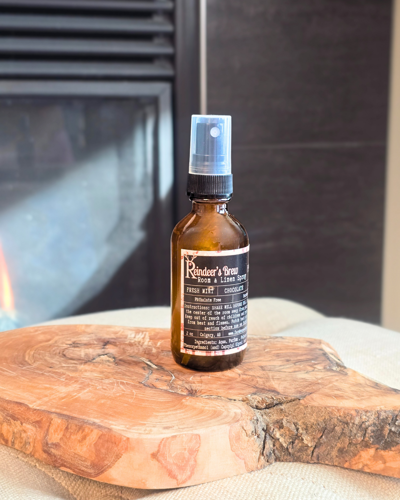 Reindeer’s Brew room and linen spray bottle — festive holiday scent from Farmhouse Charm Candles.
