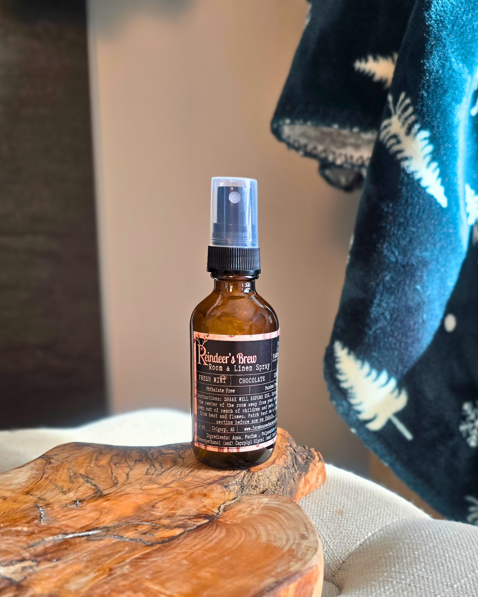 Reindeer’s Brew room and linen spray bottle — festive holiday scent from Farmhouse Charm Candles.
