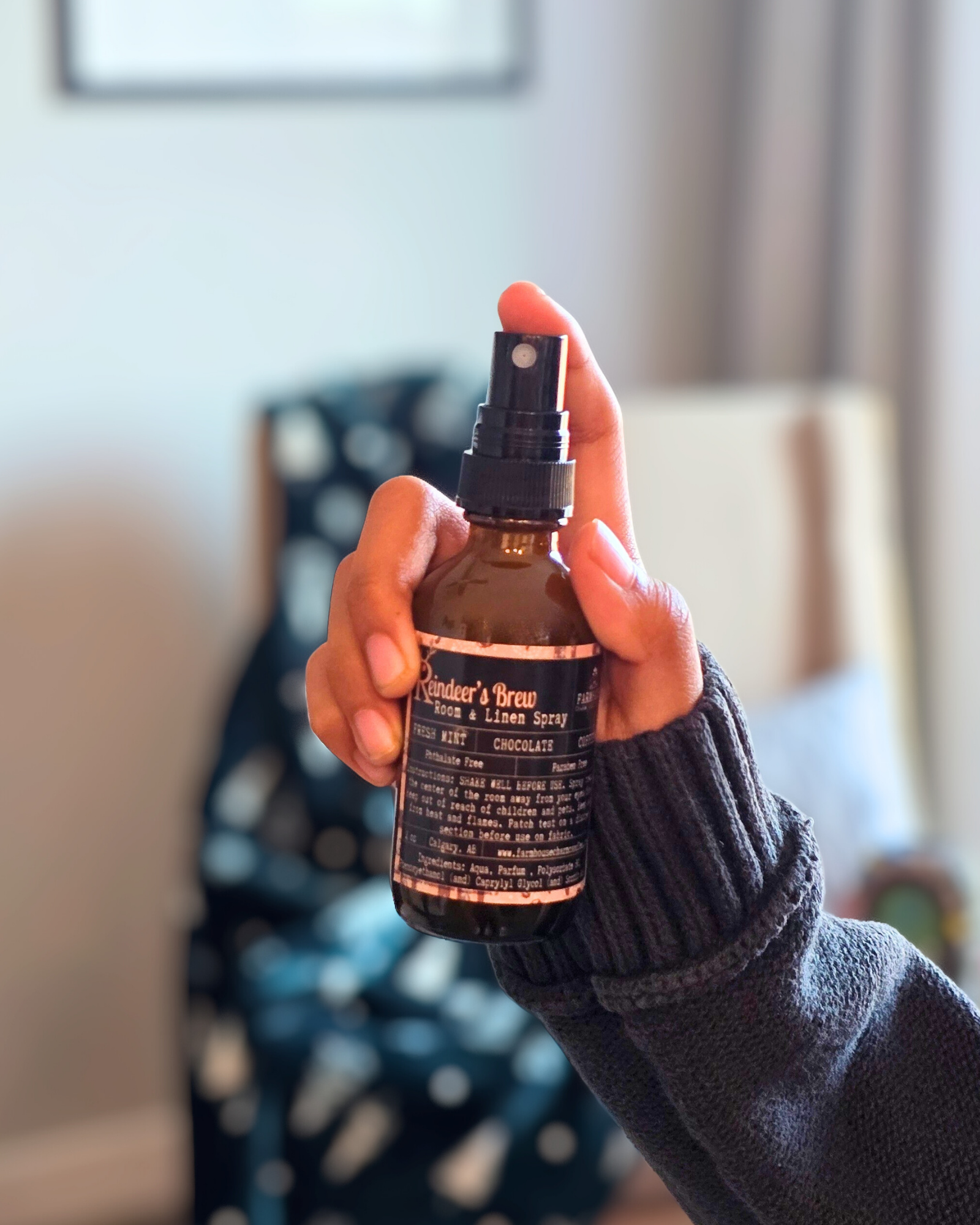 Reindeer’s Brew room and linen spray bottle — festive holiday scent from Farmhouse Charm Candles.