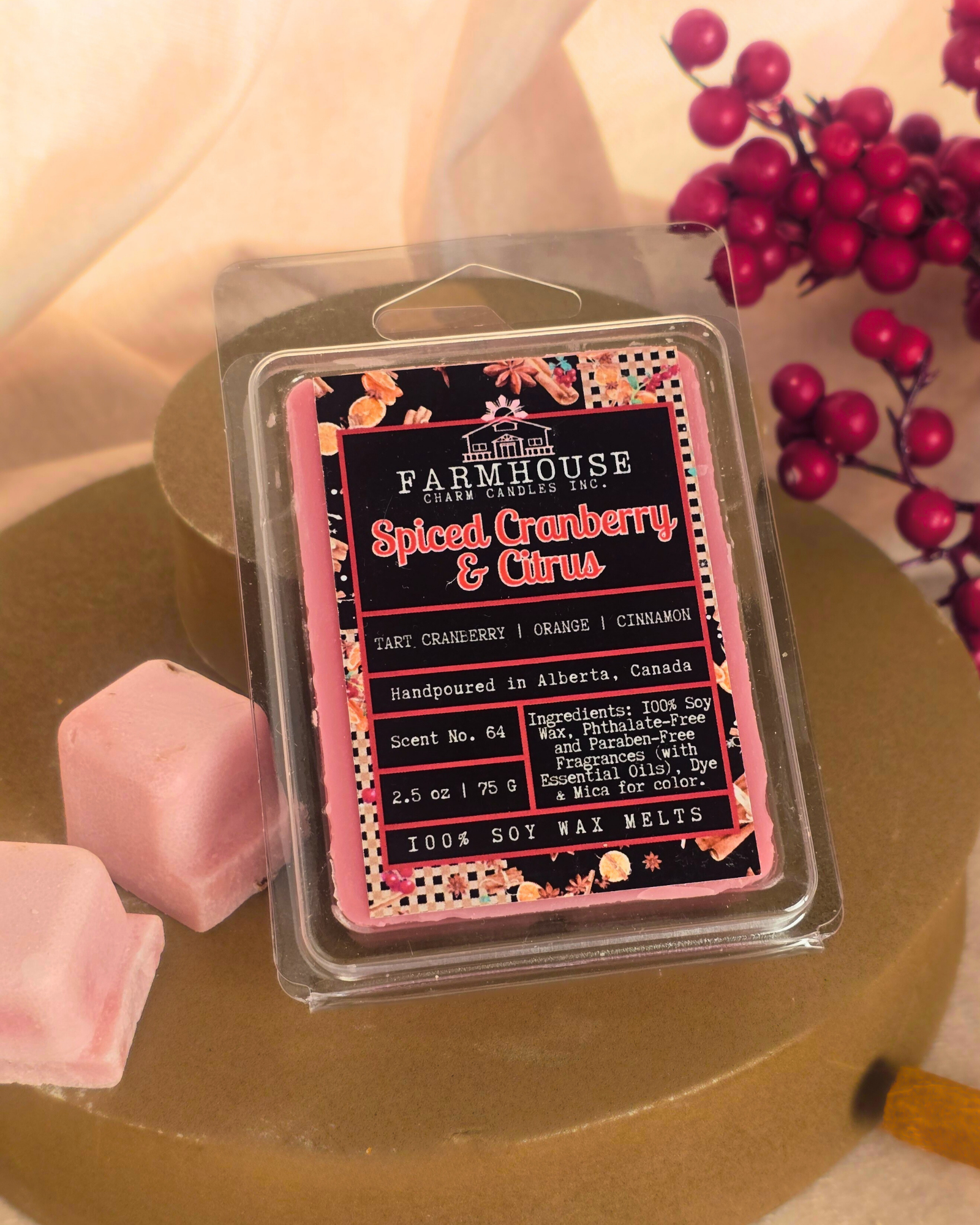 Spiced Cranberry & Citrus wax melts in wood style setting, featuring warm tones of red and orange with cozy holiday vibes — a festive blend of tart cranberry, sweet orange, and cinnamon