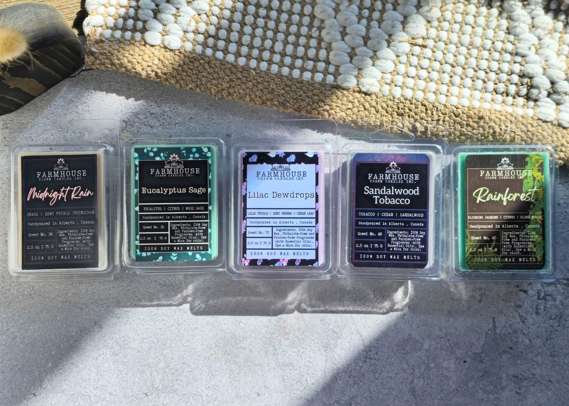 Five spring scented soy wax melts by Farmhouse Charm Candles on a textured surface with a woven mat in the background.