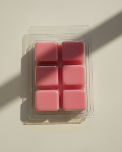 Pack of pink wax melts in a clear plastic packaging on a white background. Tomato Garden wax melts by Farmhouse Charm Candles