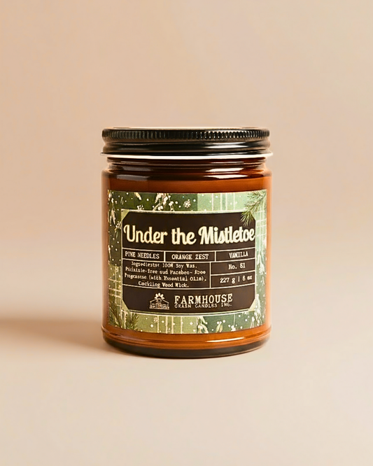 Jar of candle labeled 'Under the Mistletoe' by Farmhouse Charm Candles on a beige background