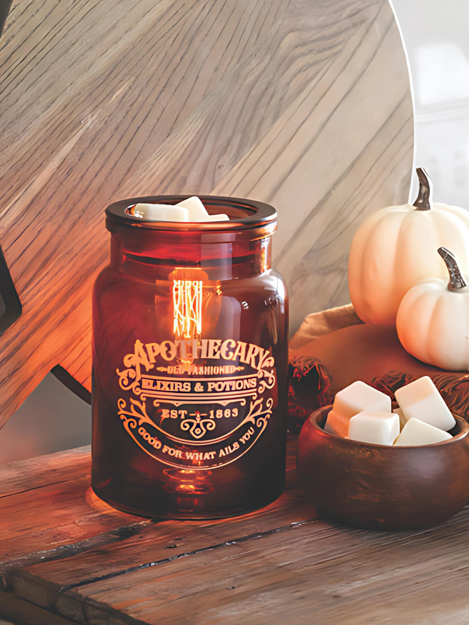 Amber glass Apothecary tart warmer with vintage Edison-style bulb, designed to melt wax safely while creating a cozy dark academia glow, perfect for farmhouse, modern, or traditional decor. www.farmhousecharmcandles.com