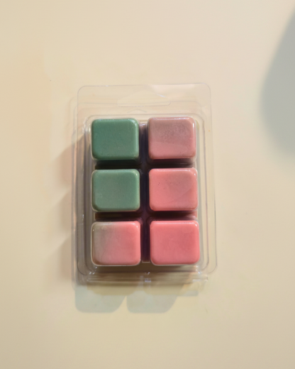 Set of six pink and green square wax melts in a clear plastic packaging on a beige background. Watermelon Sugar Wax Melts by Farmhouse Charm Candles