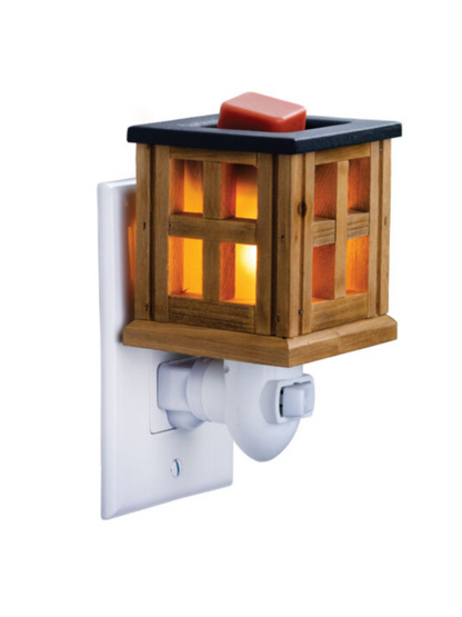Wood Lantern Pluggable Fragrance Warmer with a warm brown finish and classic lantern design, featuring a rotating plug base for vertical and horizontal outlets. Includes NP7 warming bulb and 1-year warranty.