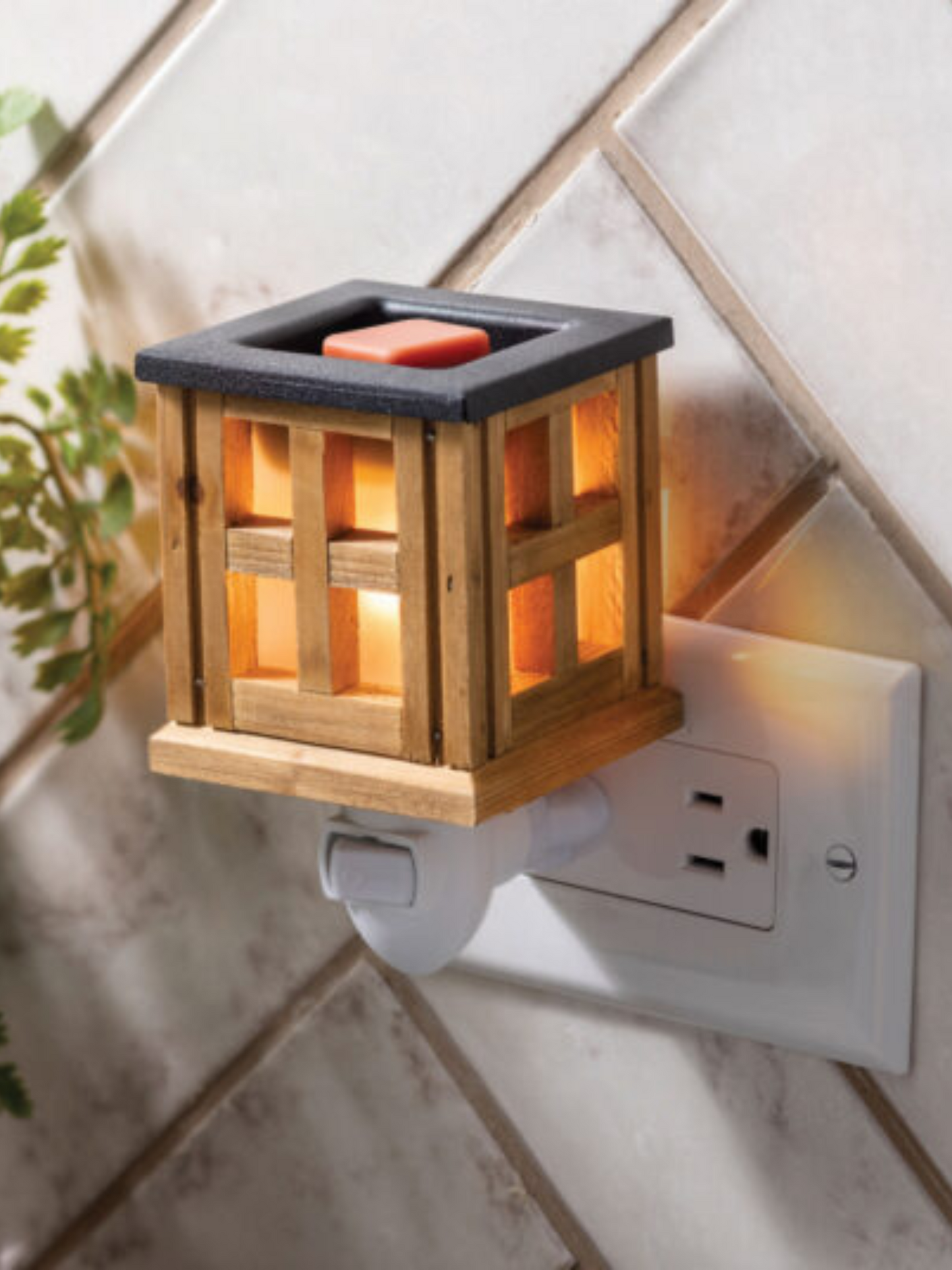 Wood Lantern Pluggable Fragrance Warmer with a warm brown finish and classic lantern design, featuring a rotating plug base for vertical and horizontal outlets. Includes NP7 warming bulb and 1-year warranty.